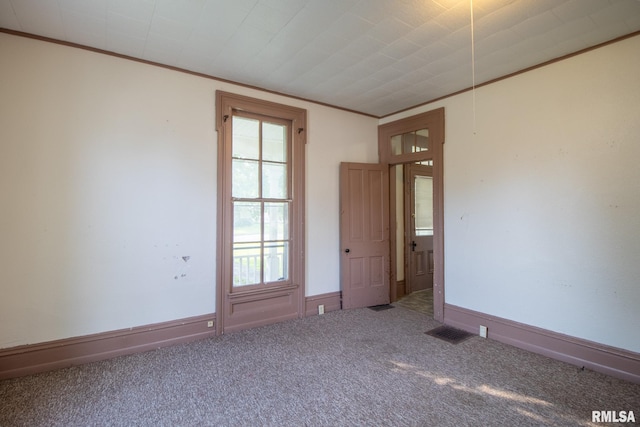 unfurnished room with carpet and ornamental molding