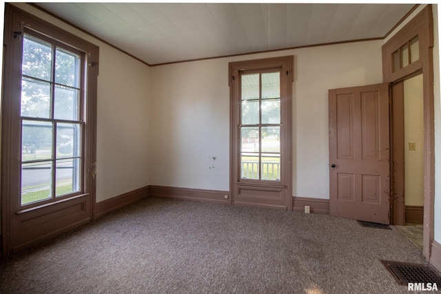 carpeted empty room featuring ornamental molding