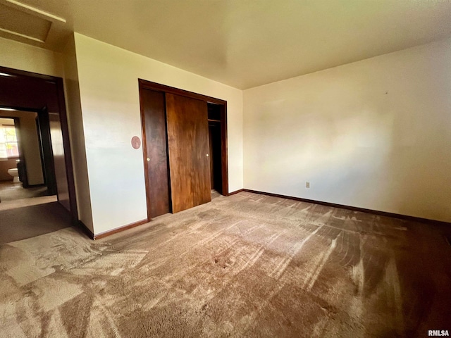 unfurnished bedroom with a closet and carpet floors