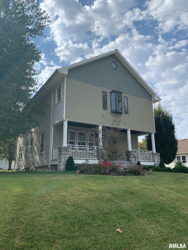 view of front of home with covered porch and a front yard