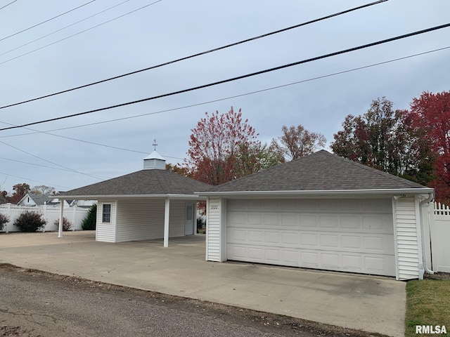 view of front of home featuring a garage and an outdoor structure