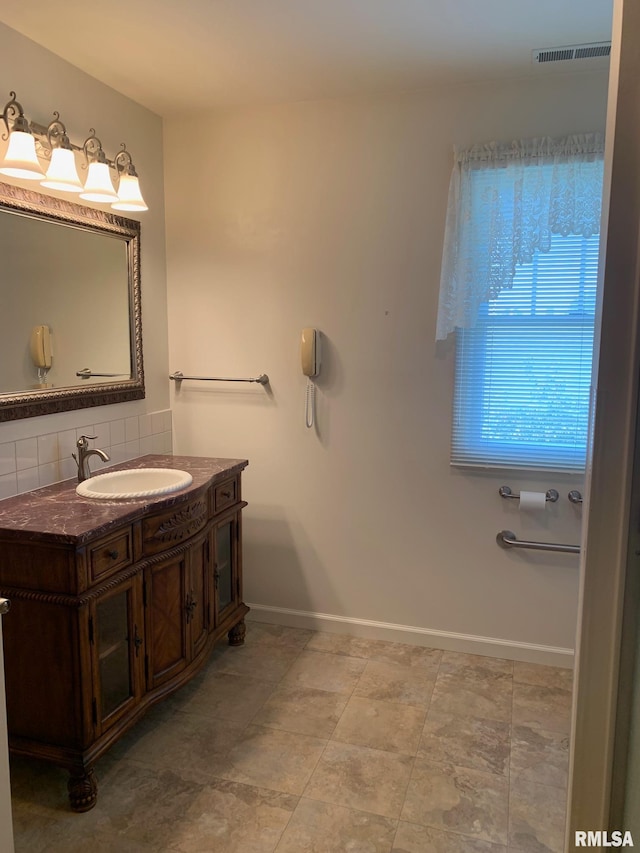 bathroom with decorative backsplash and vanity