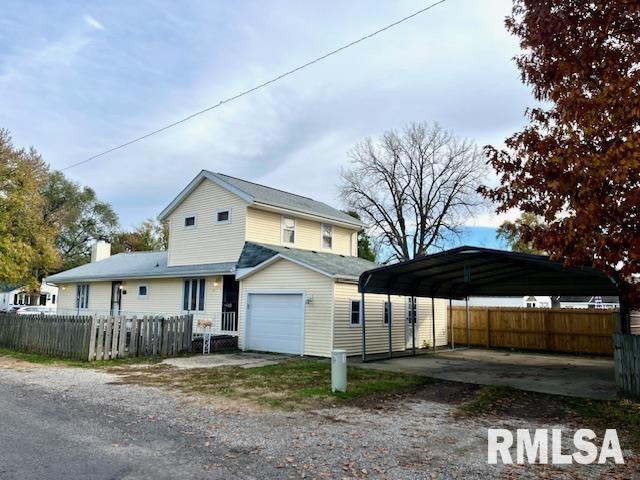 exterior space with a garage and a carport