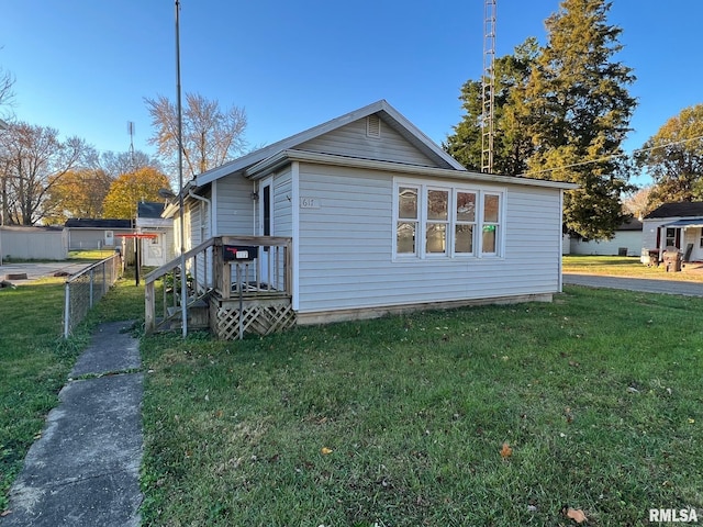 view of side of property with a lawn