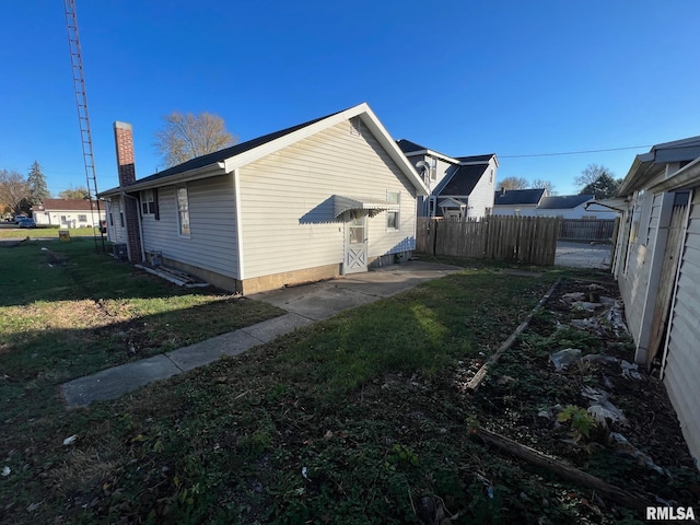 view of side of property with a lawn