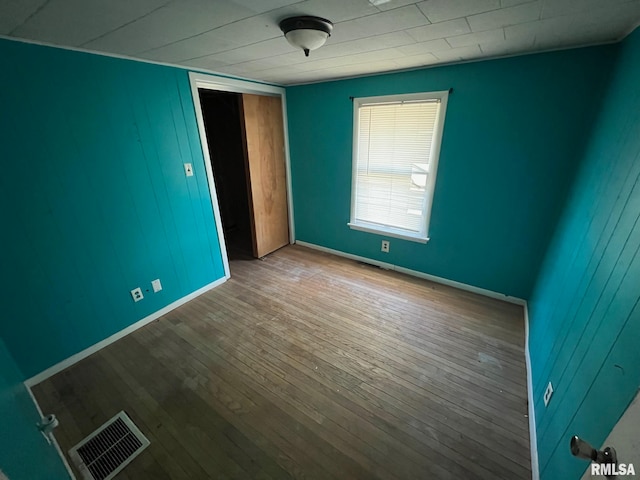 unfurnished bedroom featuring wood-type flooring and a closet