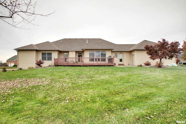 rear view of house with a lawn and a deck