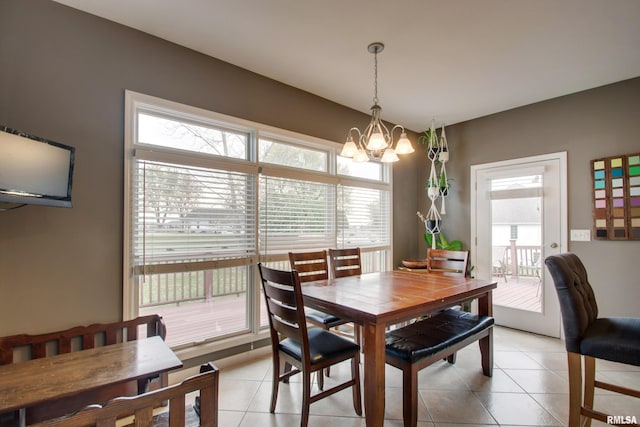 dining space with a chandelier and light tile patterned floors