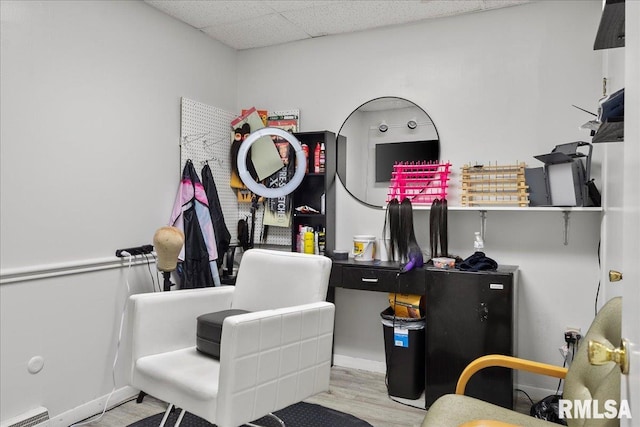 office with a drop ceiling and light hardwood / wood-style floors