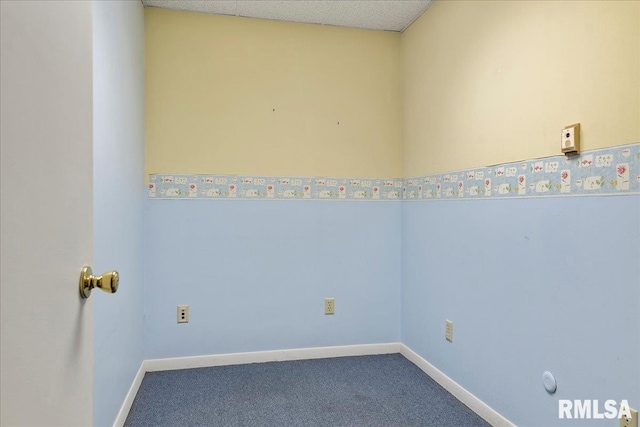 spare room featuring a textured ceiling and carpet