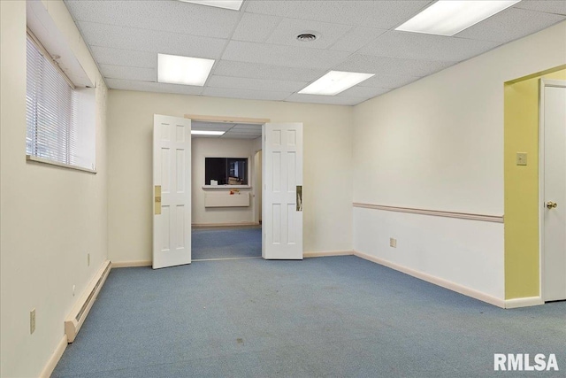 empty room with carpet and a drop ceiling