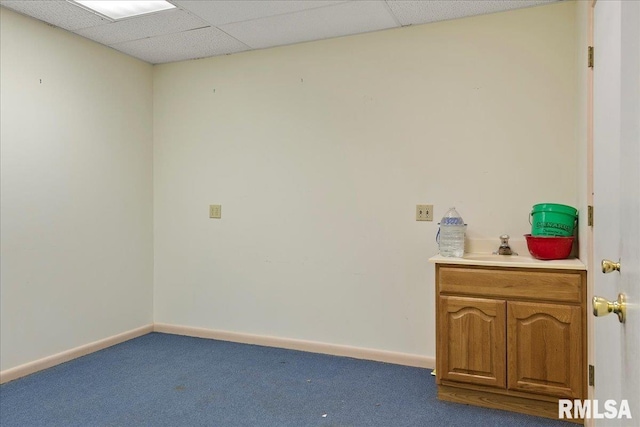 interior space featuring a drop ceiling and carpet floors