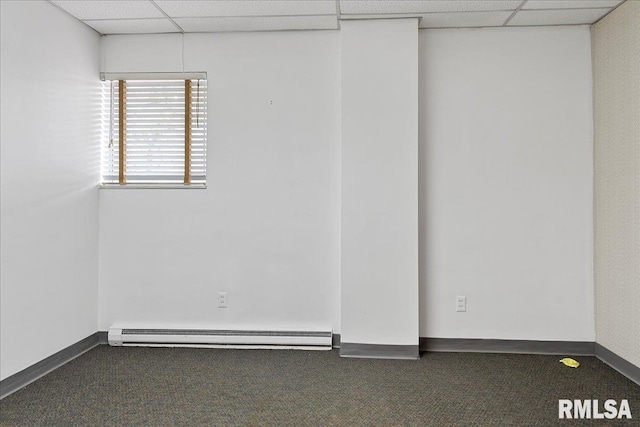 carpeted spare room featuring a drop ceiling and baseboard heating