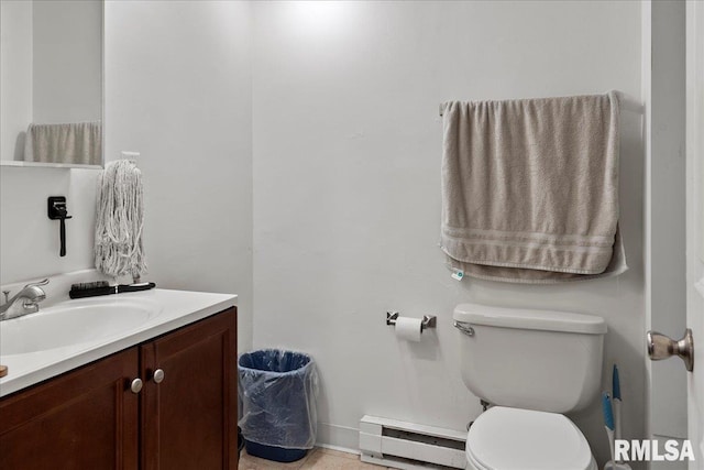 bathroom with toilet, vanity, and baseboard heating