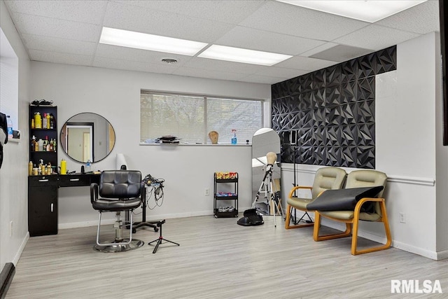 office space featuring a paneled ceiling and hardwood / wood-style flooring