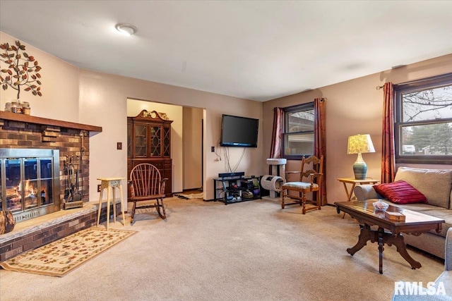 carpeted living room featuring a fireplace