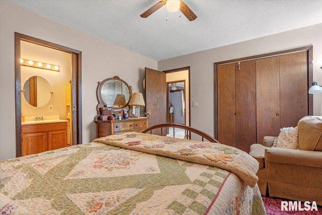 bedroom with ensuite bathroom, a textured ceiling, ceiling fan, sink, and a closet