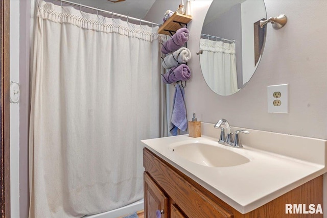 bathroom featuring vanity and a shower with shower curtain