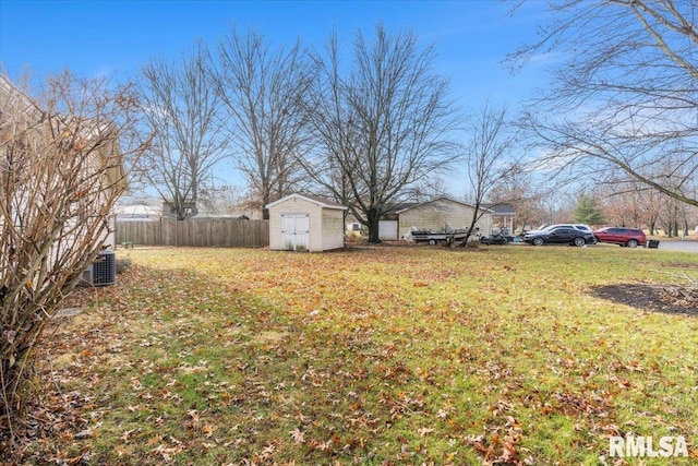 view of yard with a storage unit and central air condition unit