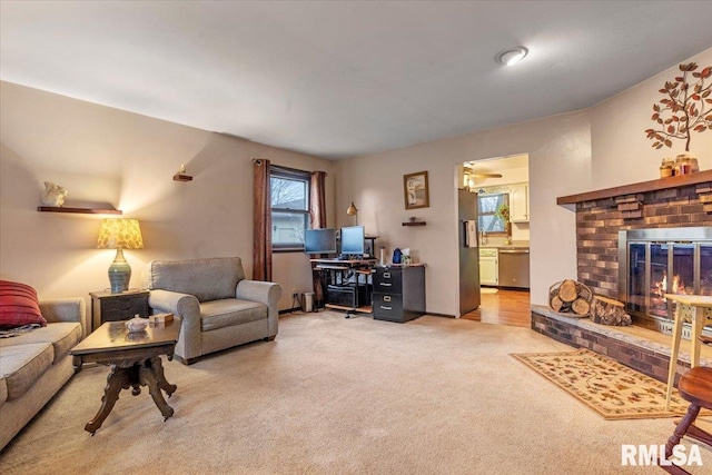 living room with light carpet and a brick fireplace