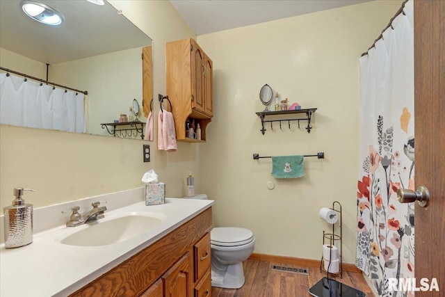 bathroom featuring hardwood / wood-style floors, vanity, and toilet