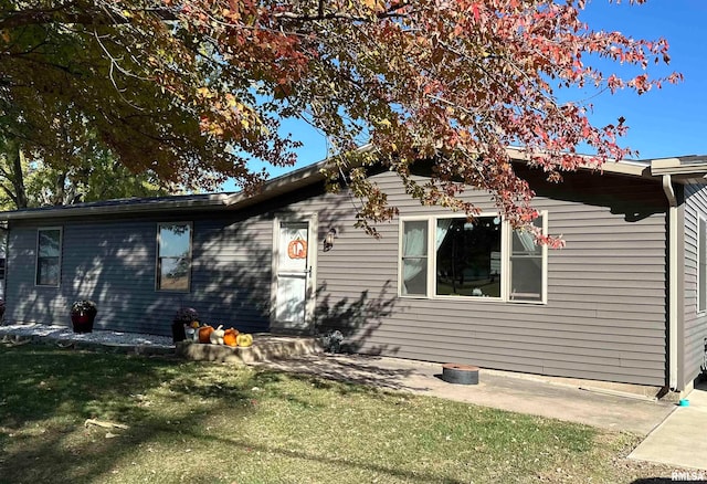 rear view of property featuring a yard