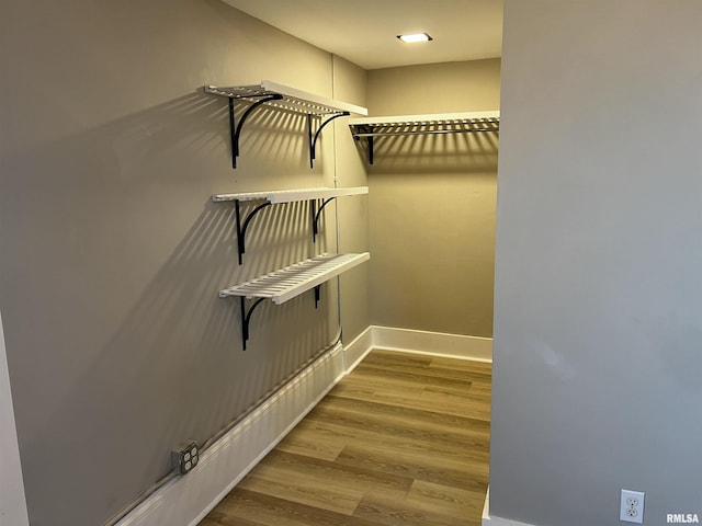 spacious closet with light hardwood / wood-style flooring