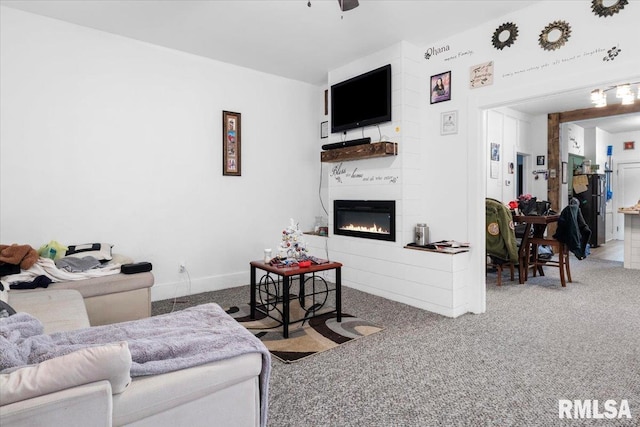 carpeted living room featuring a large fireplace