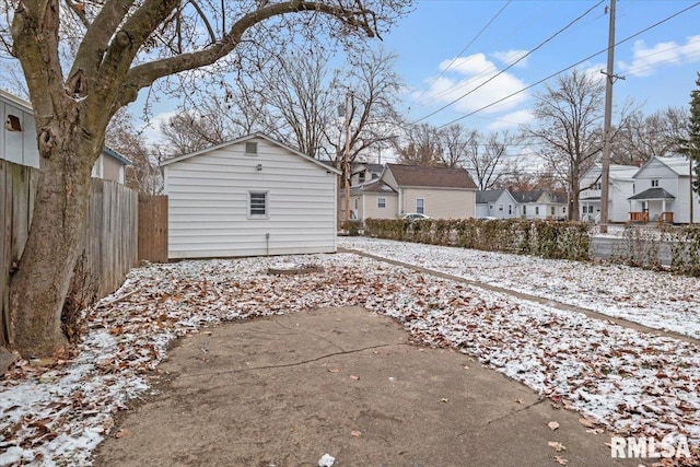 snowy yard with an outbuilding