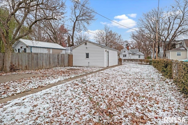 yard covered in snow featuring an outbuilding