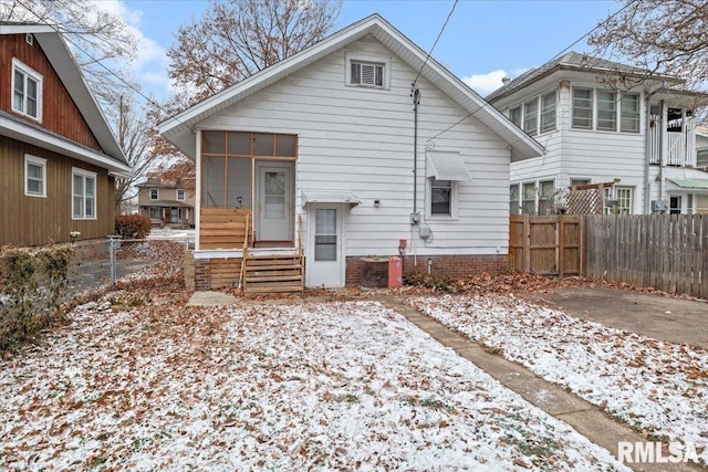 view of snow covered back of property