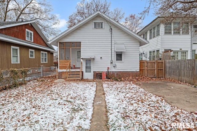 view of snow covered rear of property