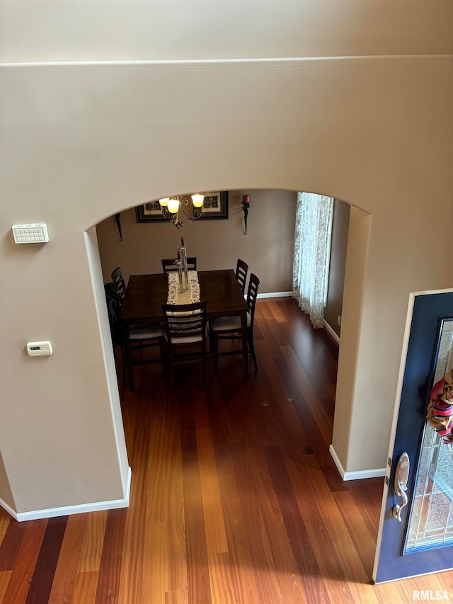 dining space with a notable chandelier and dark hardwood / wood-style floors