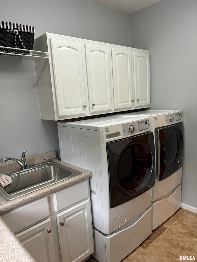 laundry room with cabinets, sink, and washer and dryer