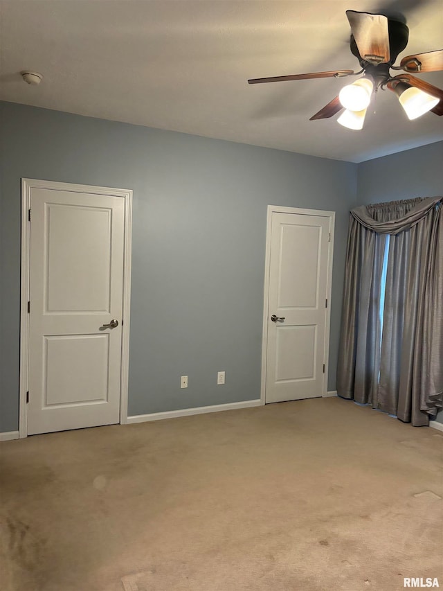 carpeted empty room with ceiling fan