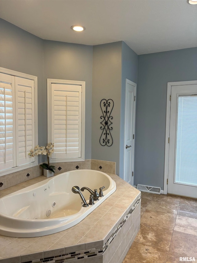 bathroom with tiled bath