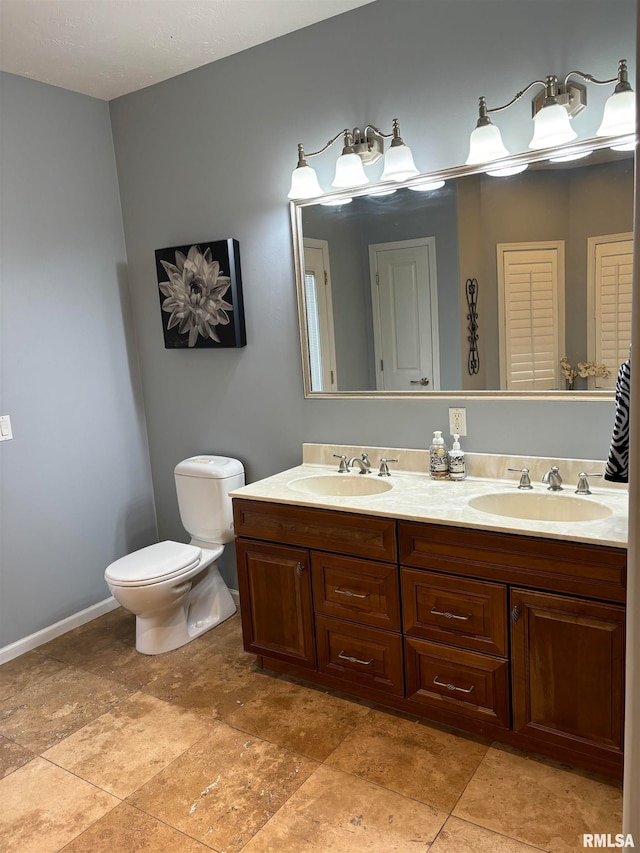 bathroom with toilet and vanity