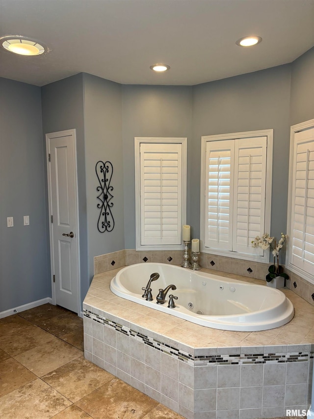 bathroom featuring tiled tub