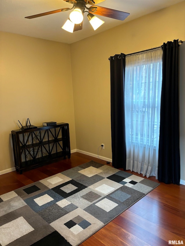 unfurnished room featuring dark wood-type flooring and ceiling fan