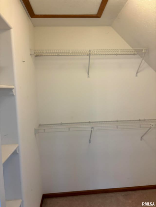 walk in closet featuring vaulted ceiling