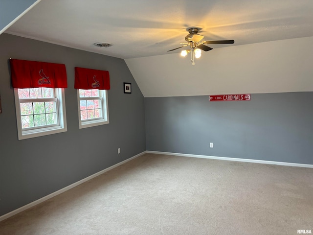 bonus room with ceiling fan, carpet flooring, and vaulted ceiling