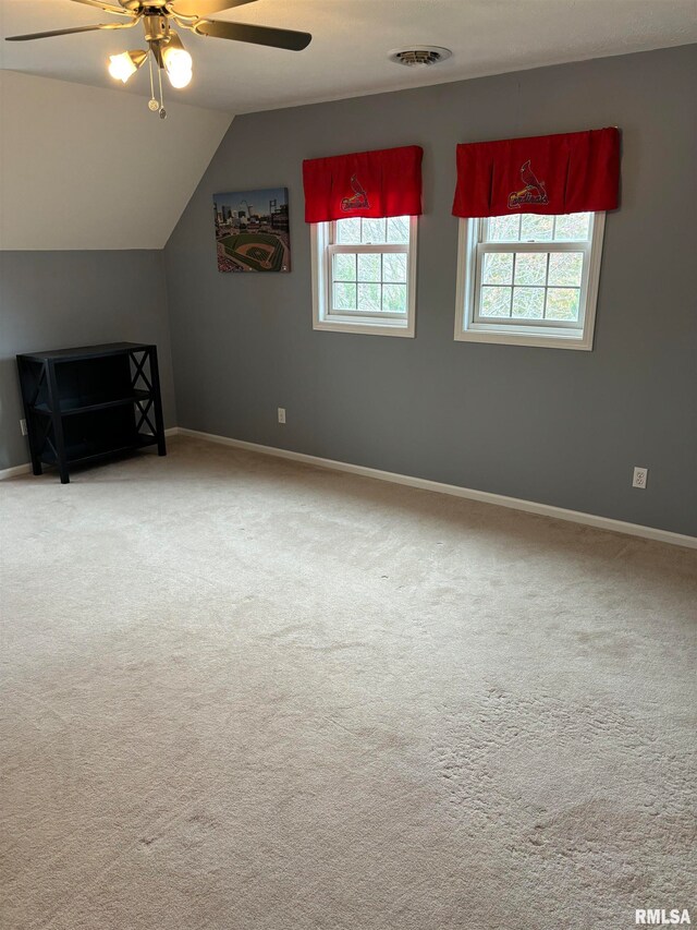 additional living space featuring carpet flooring, ceiling fan, and vaulted ceiling