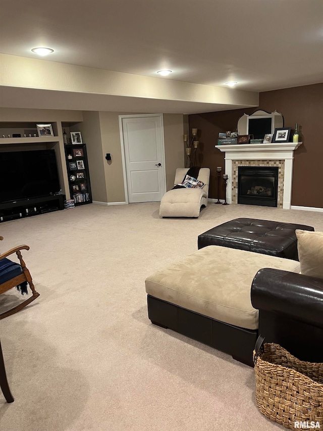 living room featuring carpet and a tile fireplace