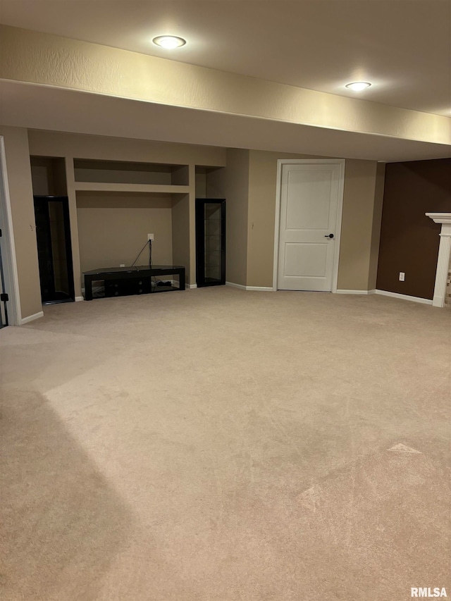 basement featuring light carpet