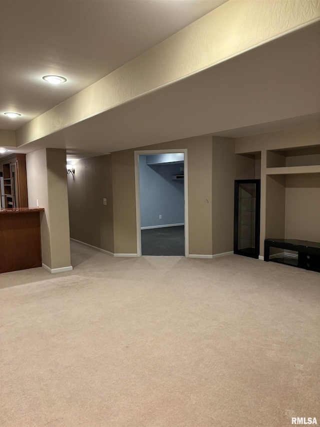 basement featuring light colored carpet