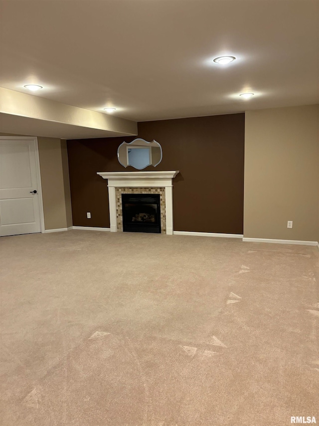 unfurnished living room featuring a fireplace and light colored carpet