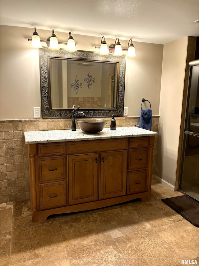 bathroom with vanity and tile walls