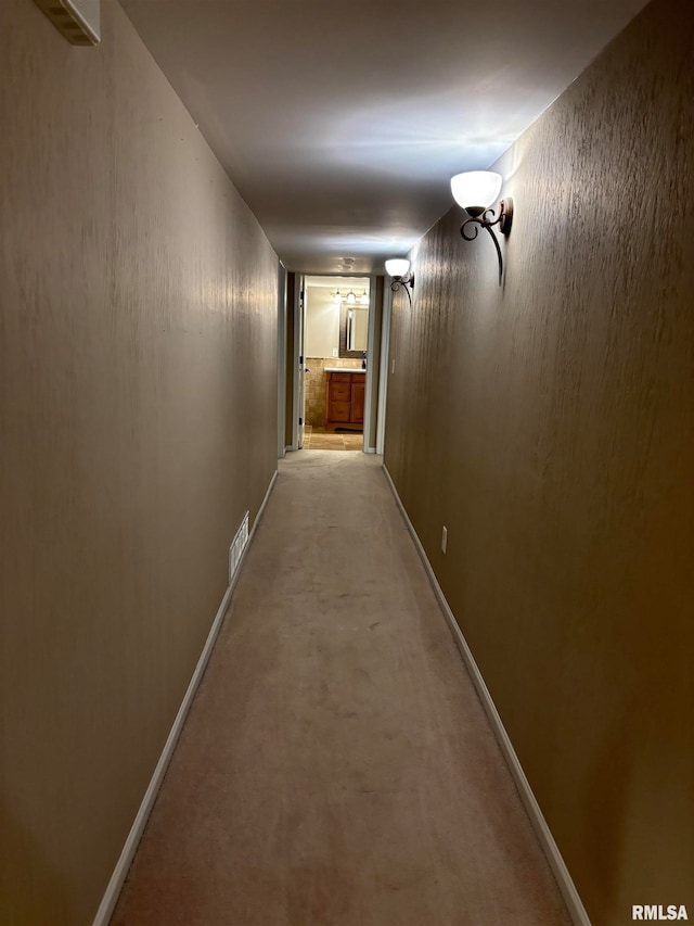 hall with light colored carpet