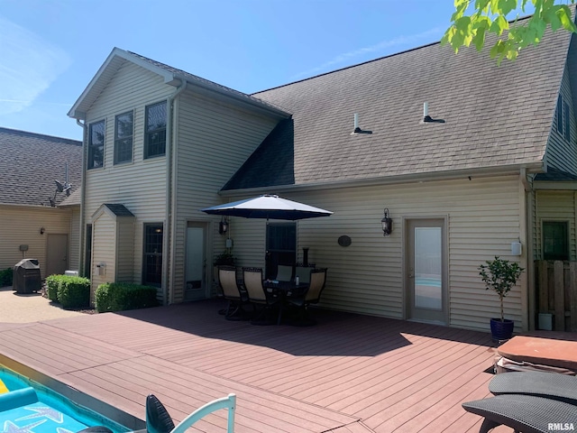 back of house featuring a deck