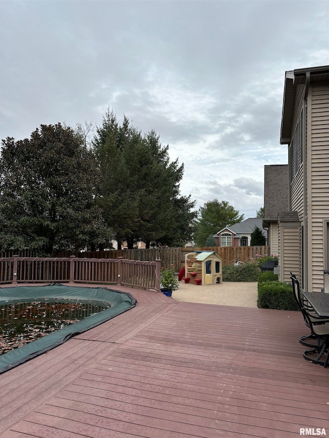 wooden deck featuring a covered pool